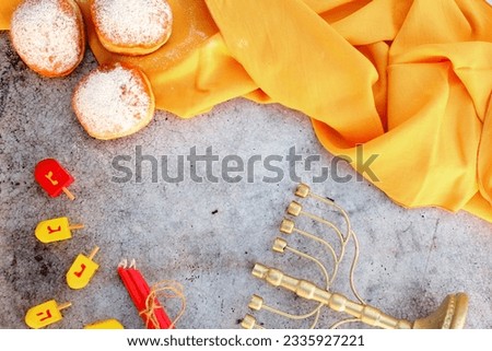 Religion image of jewish holiday Hanukkah background with dreidels (spinning top), Donuts (sufganyot) and Menorah (traditional candelabra). topshot photogrphy