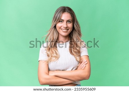 Young Uruguayan woman over isolated background keeping the arms crossed in frontal position Royalty-Free Stock Photo #2335955609