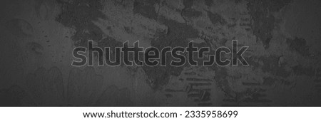 Dark panoramic background for design. Torn old faded paper wallpaper with a retro pattern. Ragged scraps of paper on a concrete wall. Shaded vintage tattered paper texture. Wide panorama with vignette Royalty-Free Stock Photo #2335958699