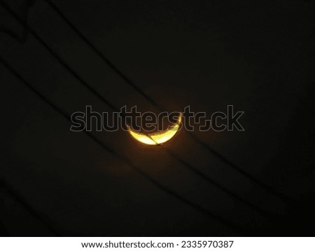 crescent moon above the power lines