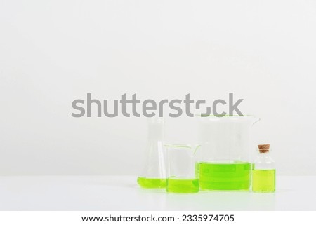 some test tube on the white table science lab with beakers, flasks, and test tubes filled with colorful liquids background
