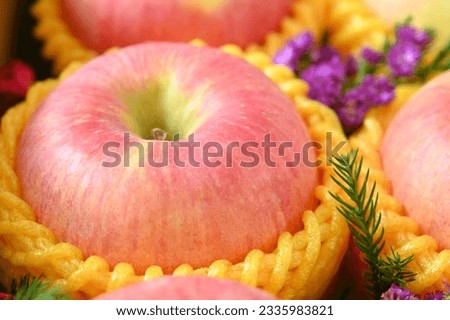 close up pink apple in yellow wrap bubble, healthy food