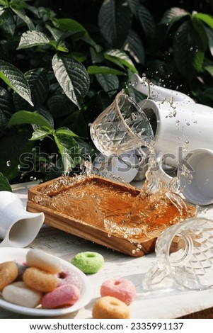 still life photography, glass filled with water spilled on the table