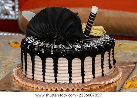 Freshly made delicious chocolate cake on brown background