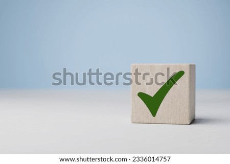 Wooden cube with green checkmark icon. Check mark, Check Mark Sign, Tick Icon, right sign,circle green checkmark button, Done. On blue background. Banner. Copy space Royalty-Free Stock Photo #2336014757