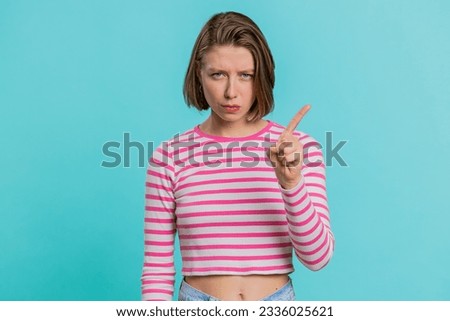 Displeased upset Caucasian woman reacting to unpleasant awful idea, dissatisfied with bad quality, wave hand, shake head No, dismiss idea, dont like proposal. Girl isolated on blue studio background Royalty-Free Stock Photo #2336025621