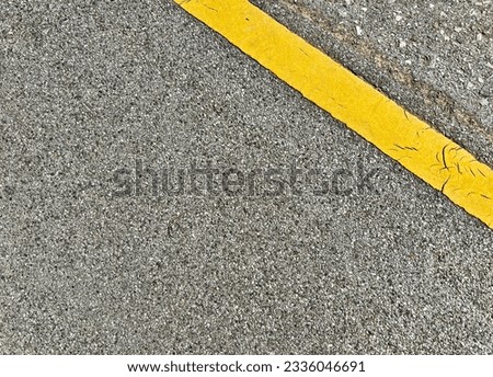 Background Image A yellow traffic line crosses a long road.