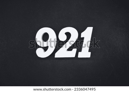 Black for the background. The number 921 is made of white painted wood.