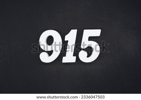 Black for the background. The number 915 is made of white painted wood.