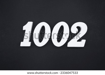 Black for the background. The number 1002 is made of white painted wood.