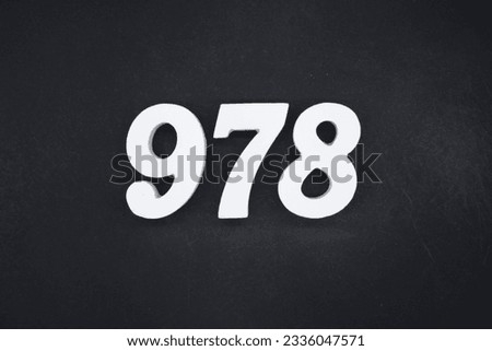 Black for the background. The number 978 is made of white painted wood.
