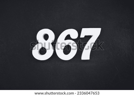 Black for the background. The number 867 is made of white painted wood.