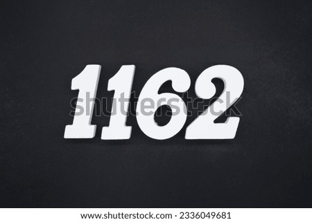 Black for the background. The number 1162 is made of white painted wood.