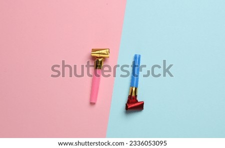 Birthday horns on pink blue pastel background. Party concept