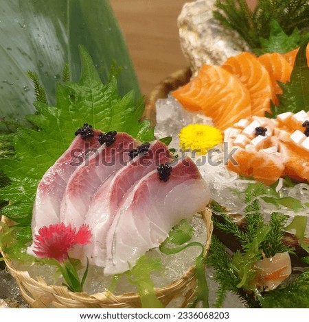 Salmon Sashimi set with fresh wasabi adding red seawood and green shi so and yellow flower Royalty-Free Stock Photo #2336068203