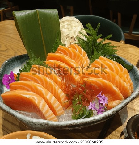 Salmon Sashimi set with fresh wasabi adding red seawood and green shi so and yellow flower Royalty-Free Stock Photo #2336068205