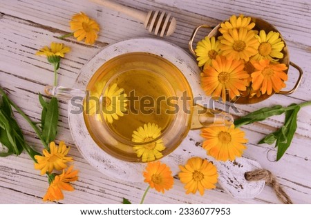Medicinal calendula flower tea with honey. Flat lay.
