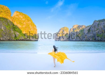 Traveler woman joy fun relaxing on sunny beach surrounded by mountains, Tourist girl on summer holiday vacation trip, beautiful place  at Maya bay, Phi Phi island, Thailand Royalty-Free Stock Photo #2336084561