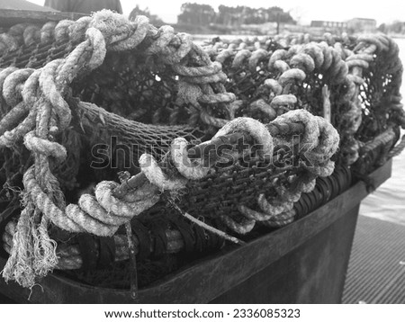 Black and white pictures of fishing gear on the dock in Beaulieu, England.         