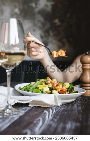 Appetizing salad with shrimps, lettuce, tomatoes and avocado. Food photography.