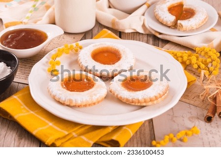 Jam filled butter cookies on white dish. Royalty-Free Stock Photo #2336100453