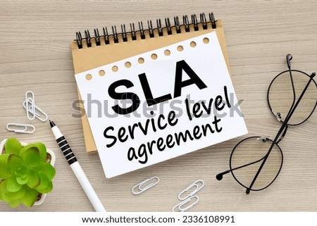 SLA - Service Level Agreement. Copy space. craft notepad with text on torn page