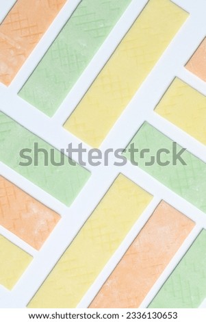 Sticks of tasty bubble gums on white background, flat lay