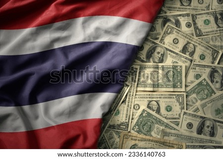 big colorful waving national flag of thailand on a american dollar money background. finance concept