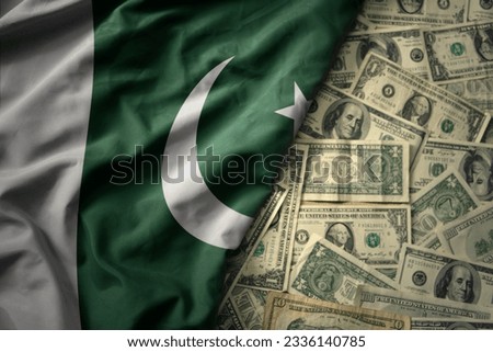 big colorful waving national flag of pakistan on a american dollar money background. finance concept