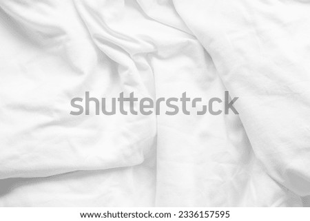 White bed sheet background, wrinkled duvet, crumpled satin blanket comforter cloth used in hotel, resort or home interior for bedding and sleep comfort