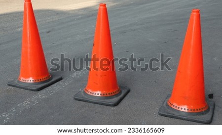 orange safety cones to indicate that there is industrial construction work or there are road warnings or roadblocks