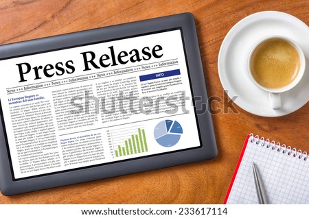 Tablet on a desk - Press Release Royalty-Free Stock Photo #233617114