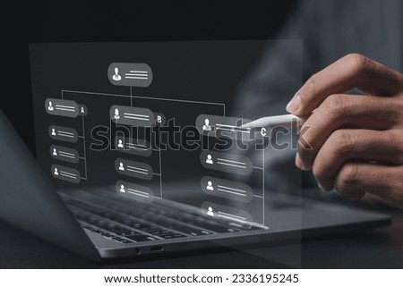 Business and technology concept. Businessman analyzing organizational chart showing business hierarchy structure, business process and workflow automation with flowchart on virtual screen. Royalty-Free Stock Photo #2336195245