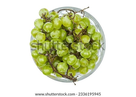 bunch of ripe fresh green grapes in glass bowl isolated on white