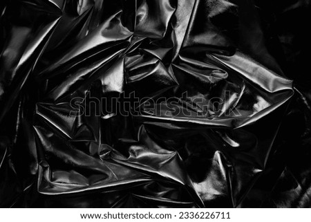 crumpled dark metallic reflector black and white background texture 