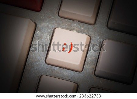 White button on a dirty old panel, selective focus - smiley