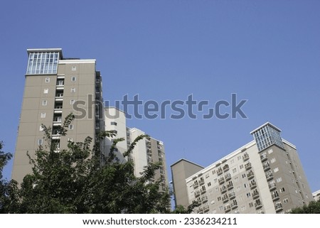 high-rise apartment building against a blue sky in the background.