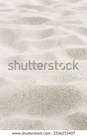 Fine Sand texture natural view. Close up of sand on shore sea, white waves dunes, beige neutral color, minimal nature aesthetic vertical photo. Sandy beach for background, selective focus, copy space