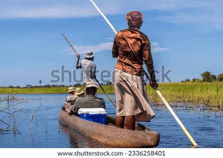 On the road in a dugout canoe through the Okavango Delta, Botswana