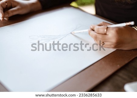 Young asian woman artist painting on canvas.
Female artist drawing with inspiration in garden