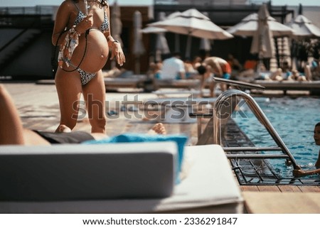  view of pregnant woman in bikini on the beach