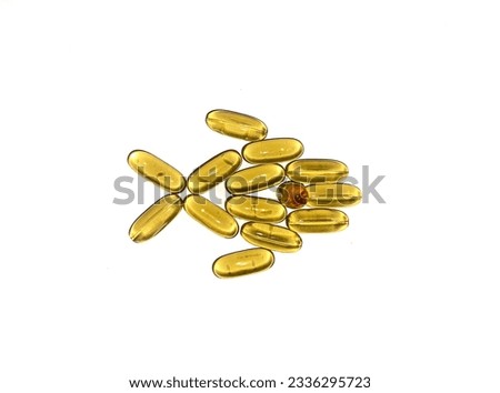 Cod liver oil capsules arranged in the shape of a fish on a white background.