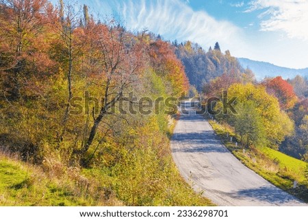 old mountain pass in fall season. countryside road trip on a sunny october forenoon. forested hills in colorful foliage