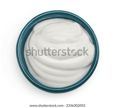 sour cream or yogurt in ceramic bowl isolated on white background with full depth of field. Top view. Flat lay