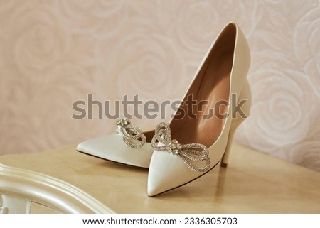 Beautiful white women's shoes with rhinestones. Shoes for weddings or special events. Royalty-Free Stock Photo #2336305703