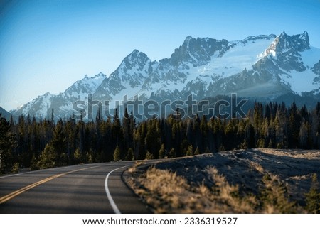 Tranquil Winter Landscape: Snowy Mountain Pass Through Pine Woodland Royalty-Free Stock Photo #2336319527