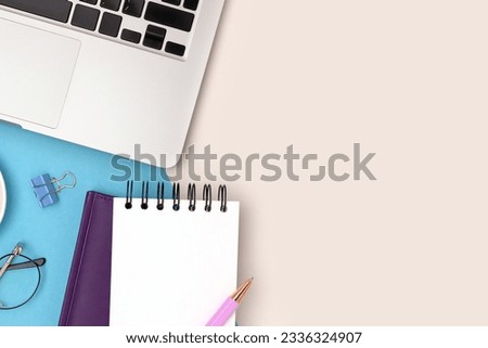 Workspace with laptop and stationery on a blue and gray background. Business concept.