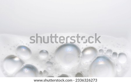 Foam border design on white background. Liquid soap bubbles, Foam bubbles background. Soap foam popping bubble, white backdrop. Soap sud macro structure. Soap foam close-up. Clean, cleaning, washing 