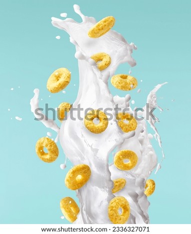 Tasty ring cereals with milk splashes falling in the air isolated. Food levitation conception. High ewsolution image