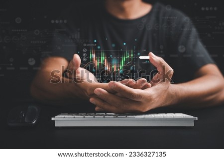 Trader or investor man presents a hologram of a growing stock chart on his palm in a close-up. Stock market data analysis, strategic planning, and business growth concepts. Empower your success. Royalty-Free Stock Photo #2336327135